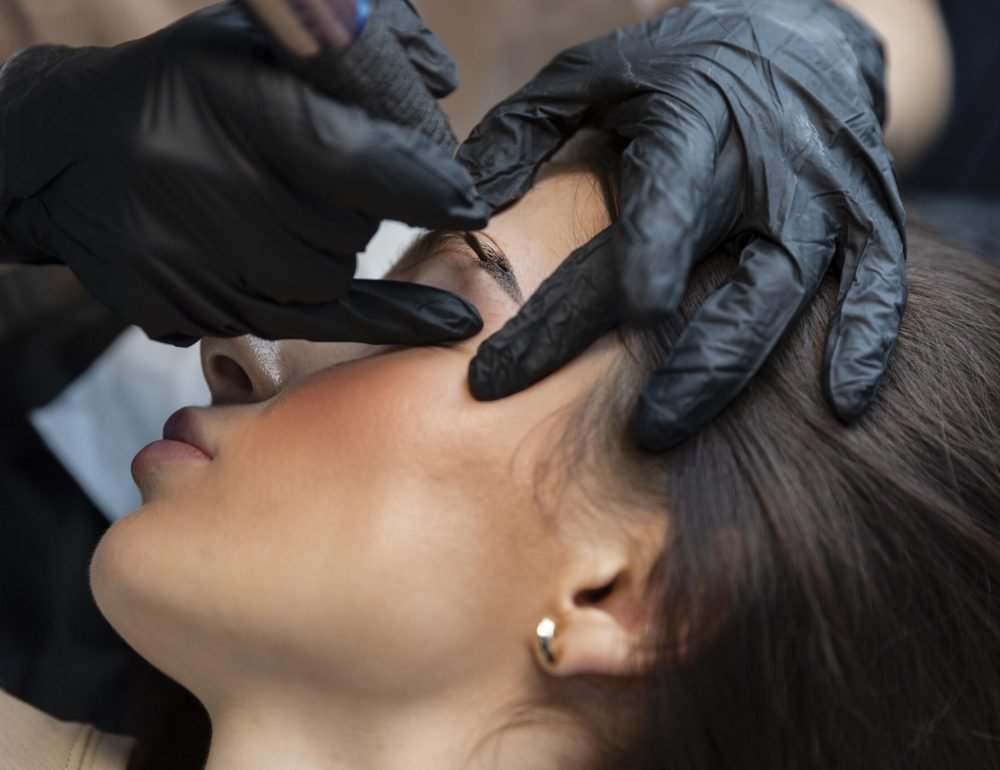 young-woman-getting-beauty-treatment-her-eyebrows